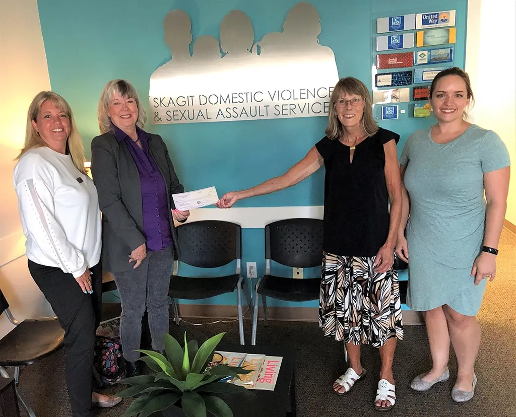 Skagit Domestic Violence & Sexual Assault Services receiving a donation from the Thelma & Louise Fundraising Project